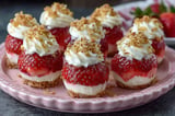 A plate of strawberry cheesecake desserts.