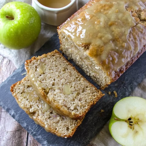 A slice of glazed apple cinnamon oatmeal bread.