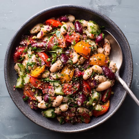 A bowl of bagel dense bean salad.